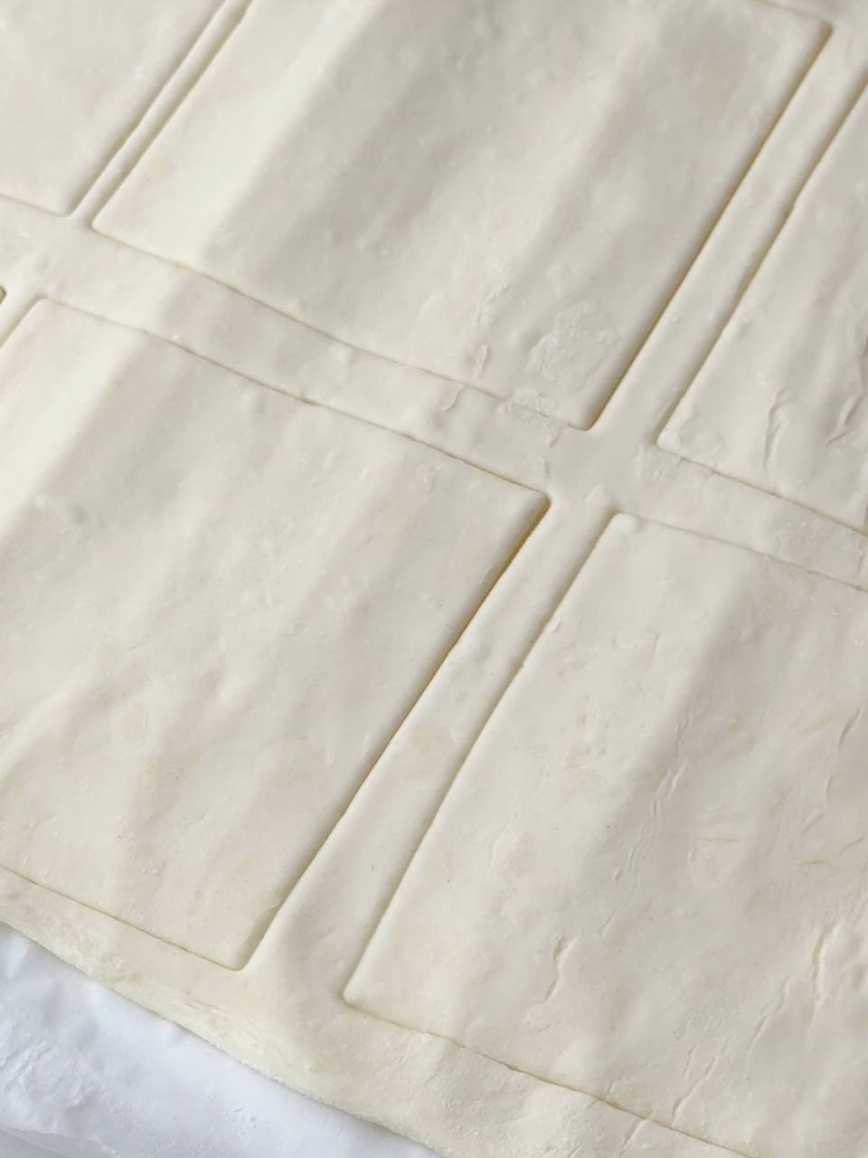 Cutting puff pastry into squares for heart pastries