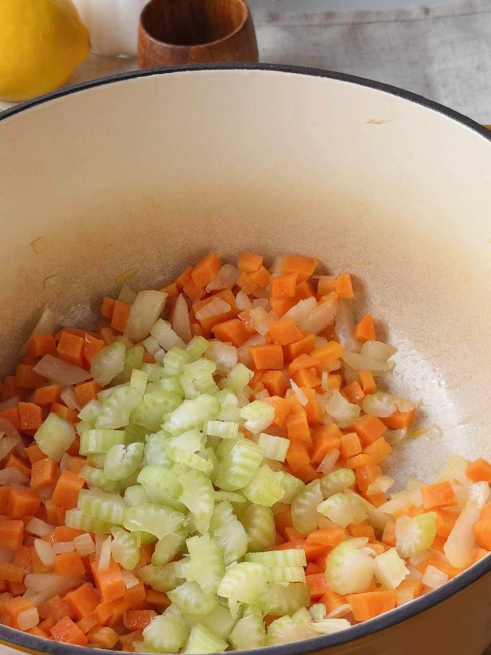 Onion, carrot, and celery sautéing in olive oil for the base of creamy lentil soup.