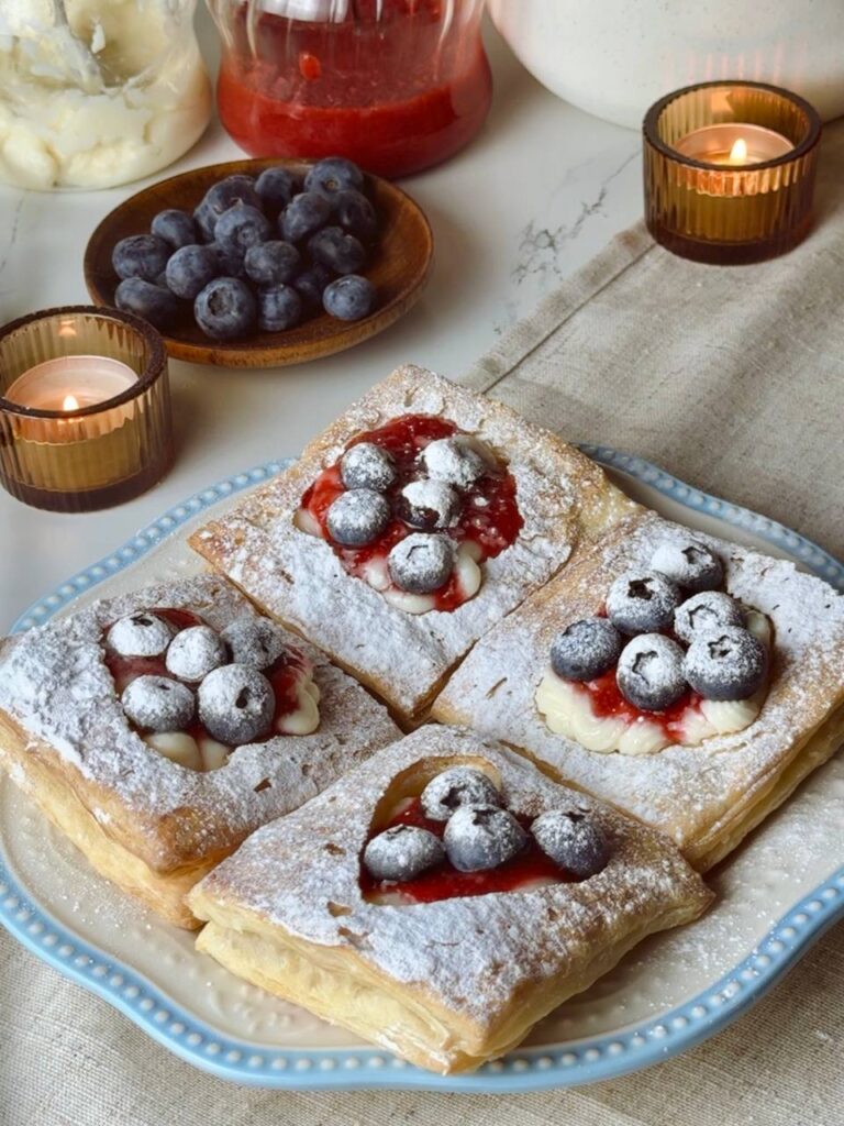 Served puff pastry hearts dessert with berries and custard