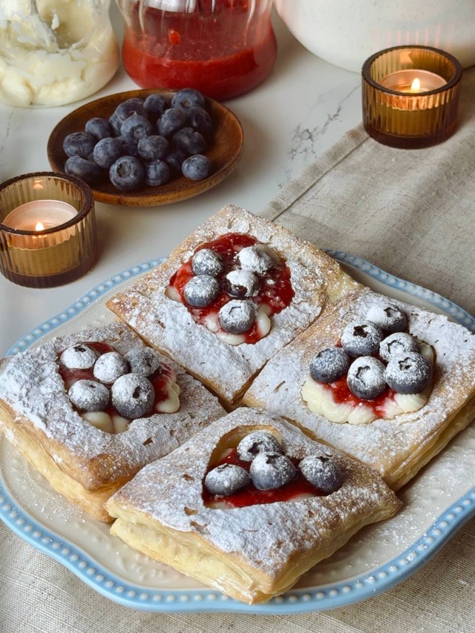 Served puff pastry hearts dessert with berries and custard