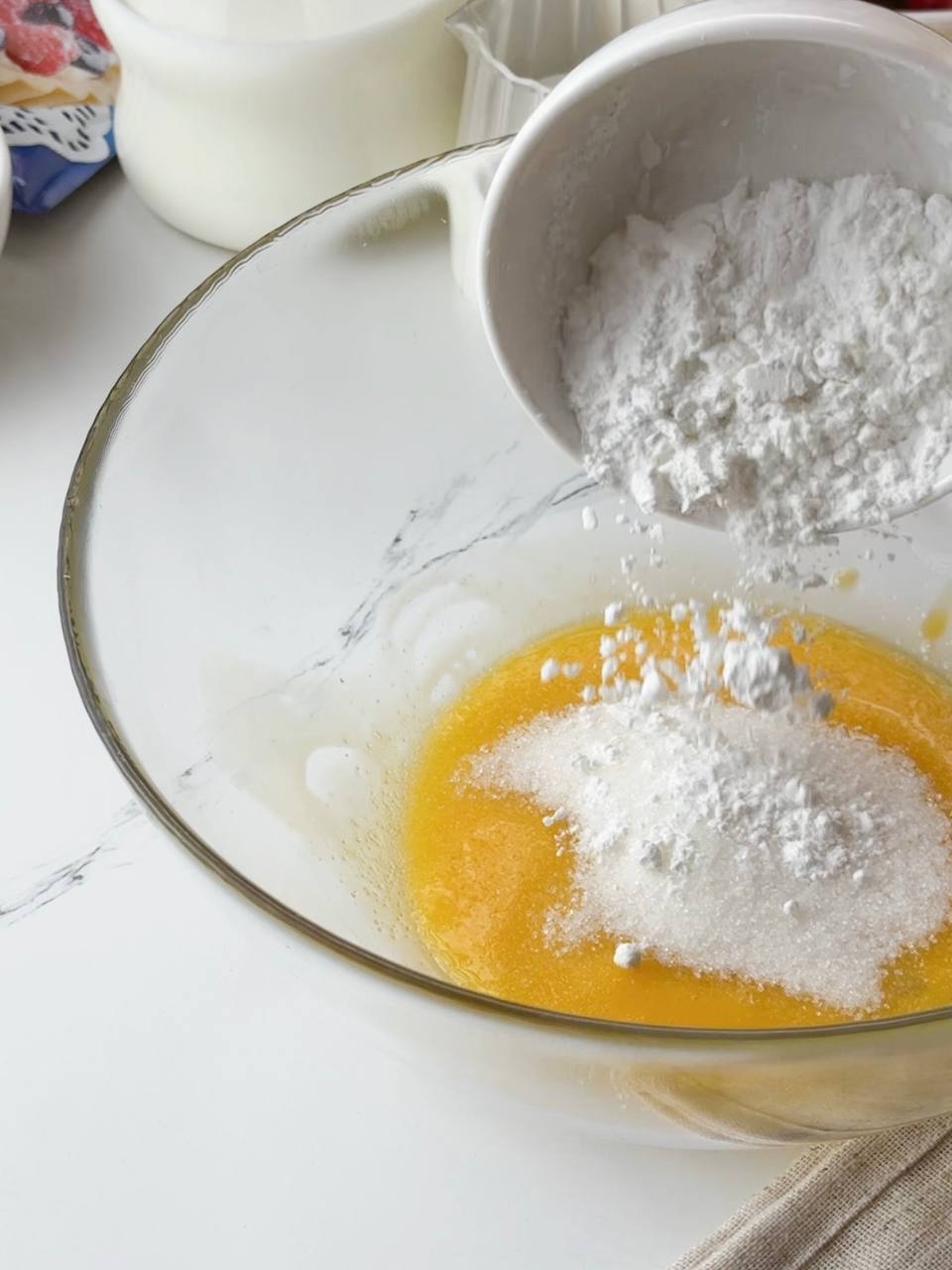 Whisking egg yolks, sugar, and cornstarch for creamy custard