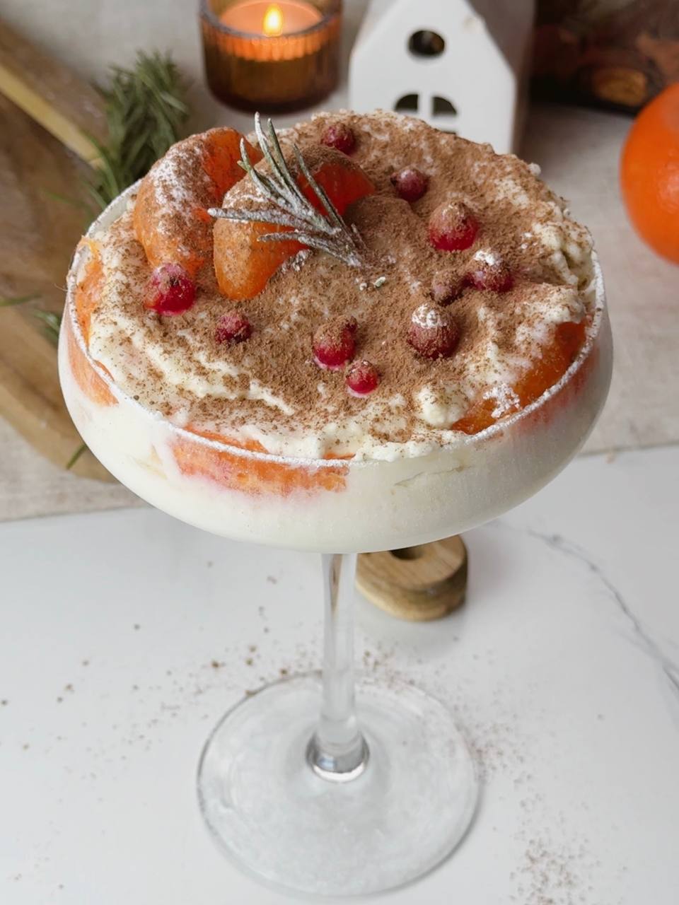 No-bake clementine tiramisu decorated with cocoa and cranberries