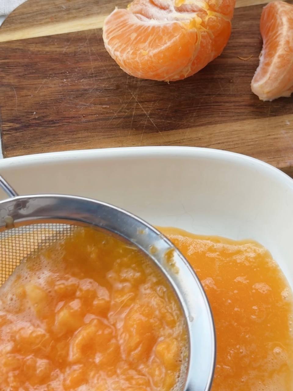Straining clementine juice for smooth dessert layers