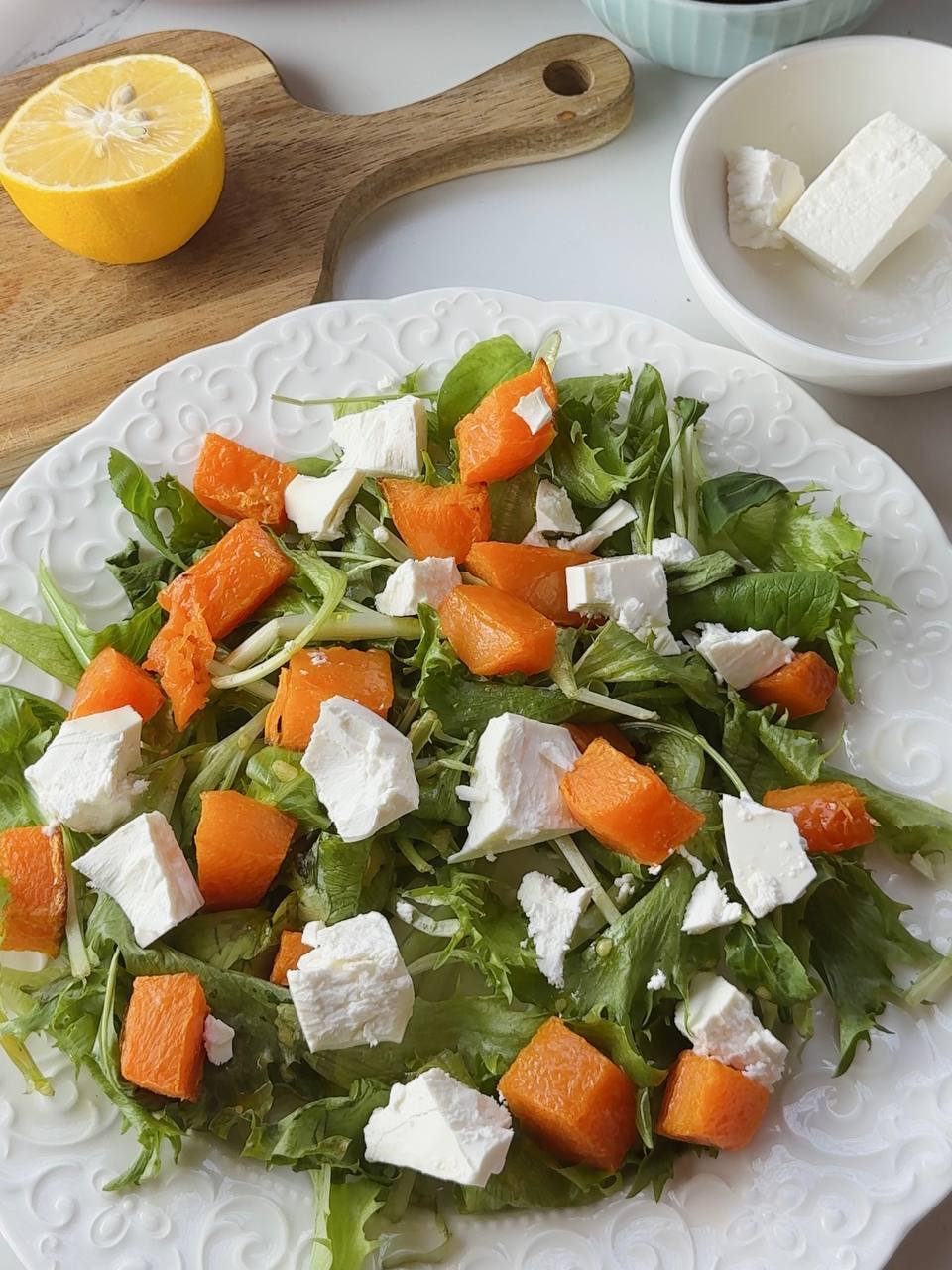 Adding warm baked pumpkin and hand-crumbled feta over greens for cafe-style pumpkin salad