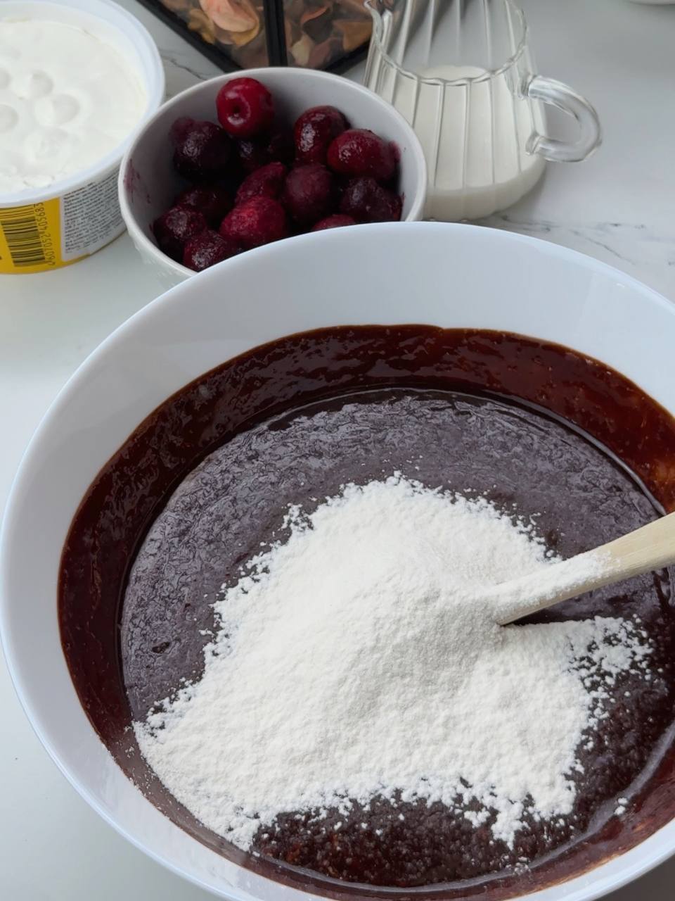 Folding flour into chocolate brownie batter