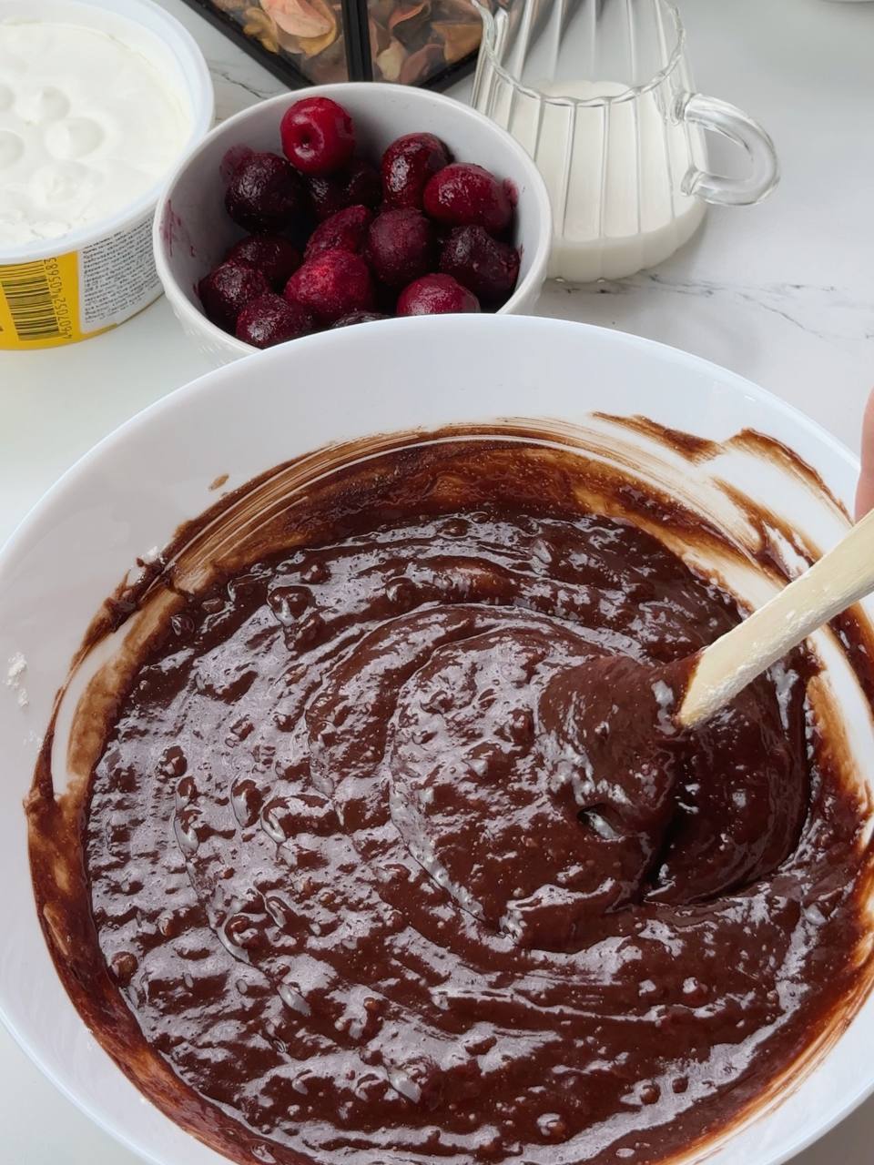 Mixing eggs with melted chocolate and butter