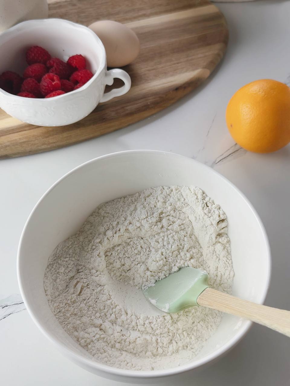 Dry ingredients mixed in a white bowl for lemon yogurt pancakes