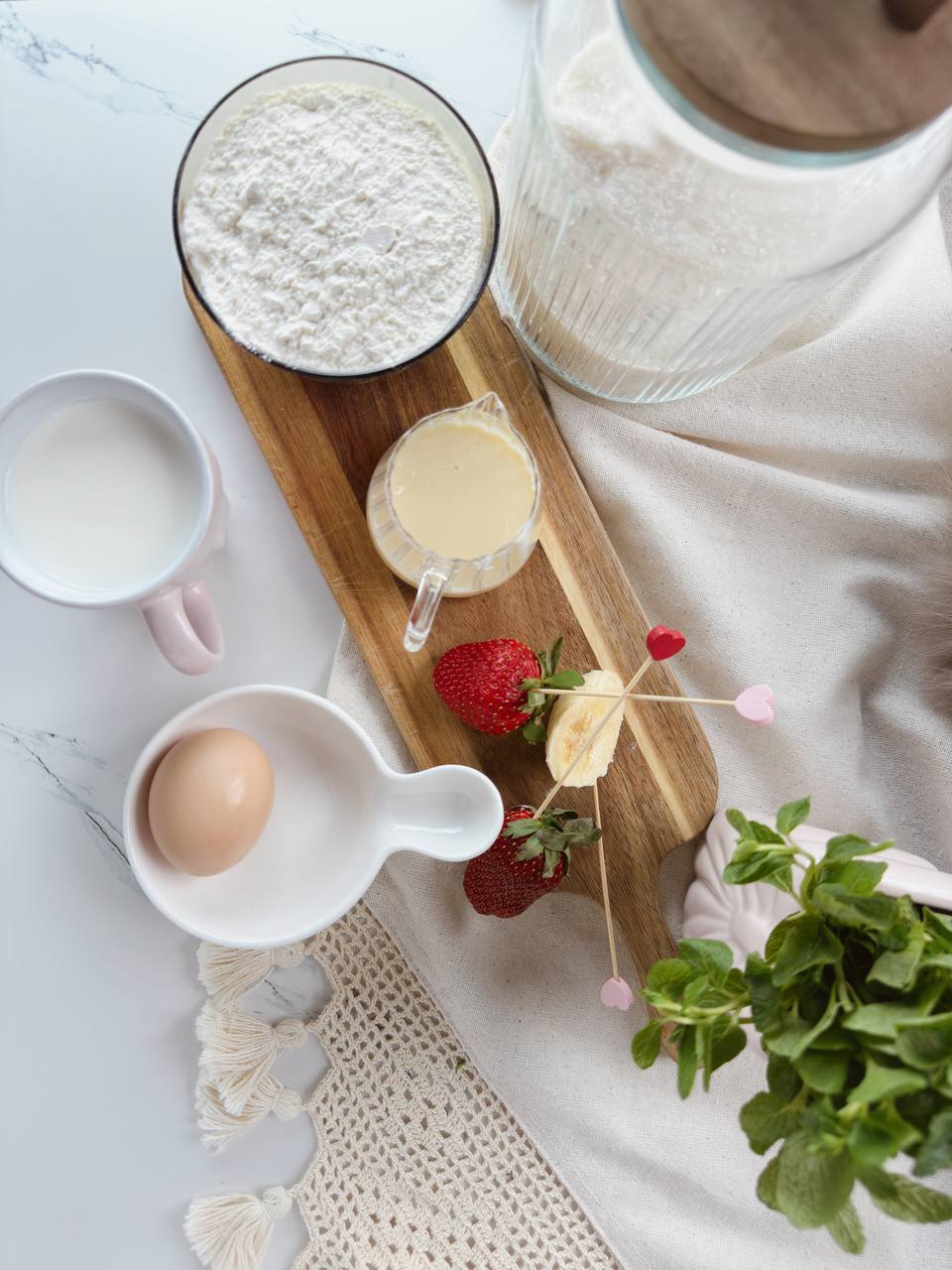 Ingredients for heart shaped pancakes with flour, milk, egg, and sugar