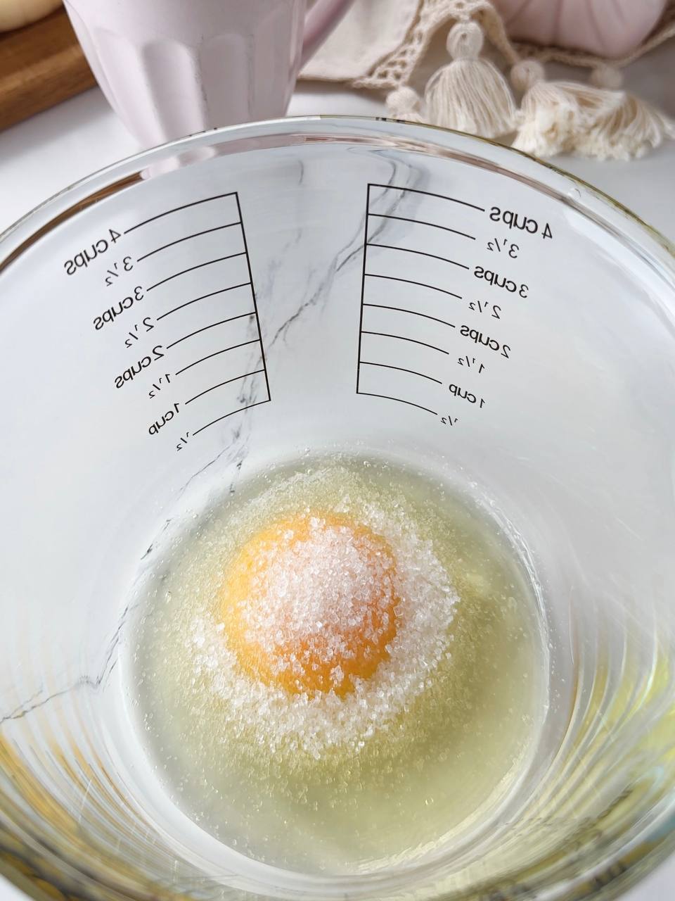Mixing egg and sugar for fluffy pancake batter