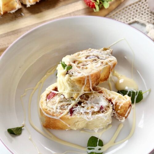 Served strawberry cream oven baked pancake roll with powdered sugar