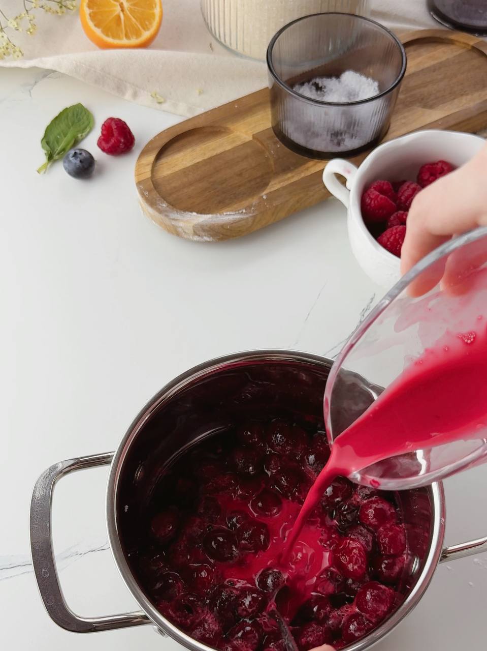 Adding cherry juice with cornstarch to simmering cherries