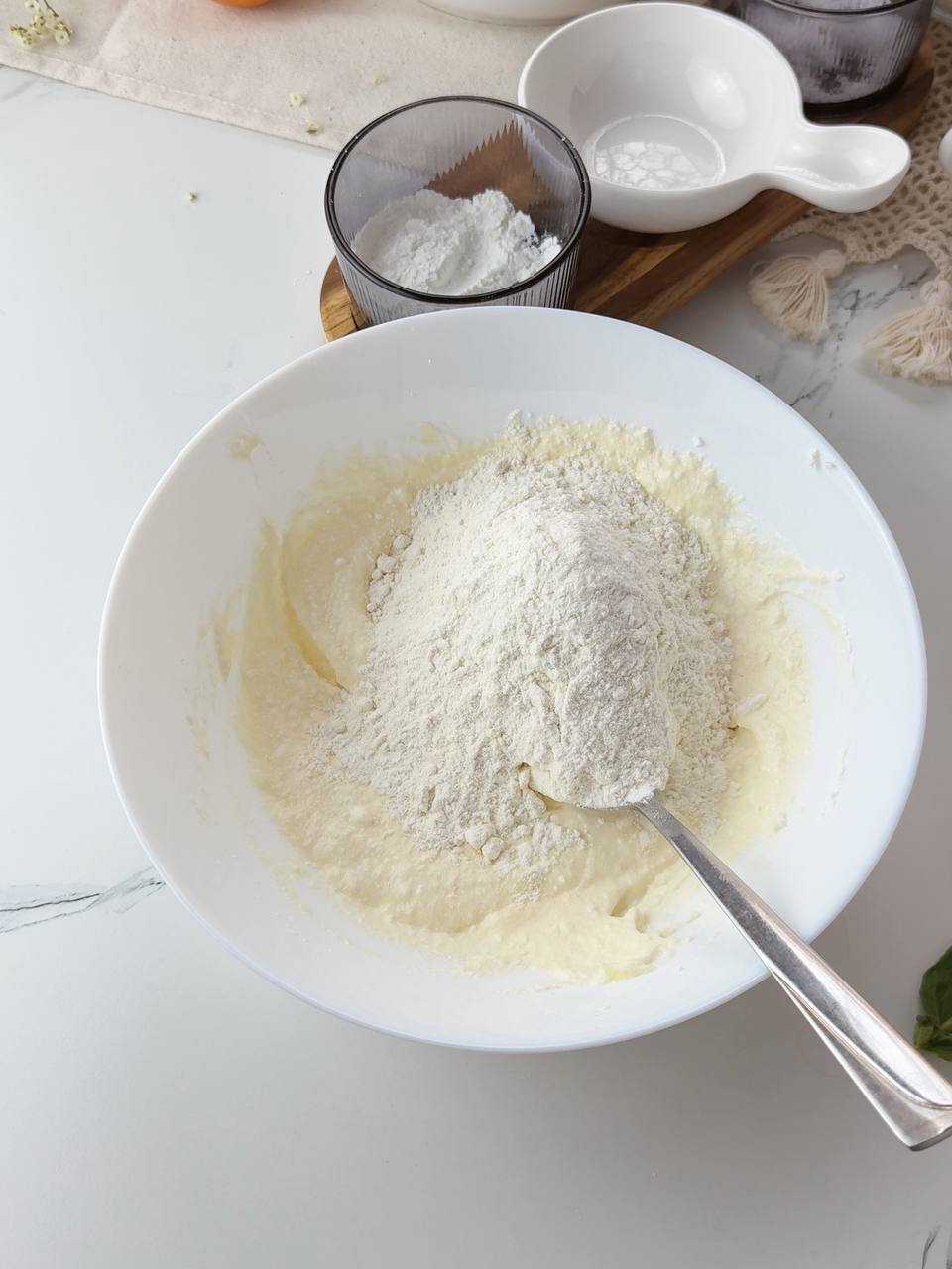 Adding flour to cottage cheese mixture to make soft galette dough