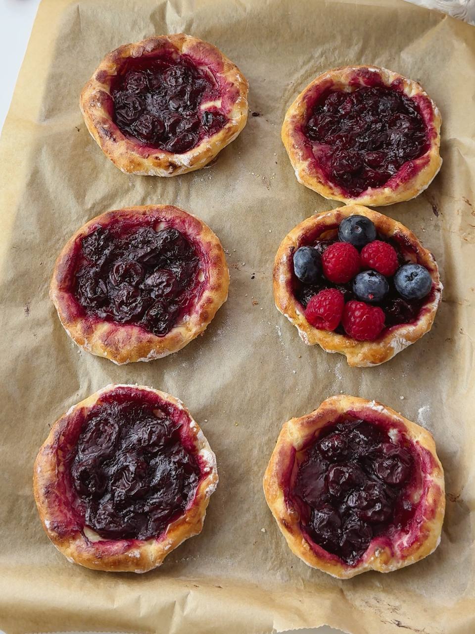 Freshly baked cherry cottage cheese galettes with golden crust