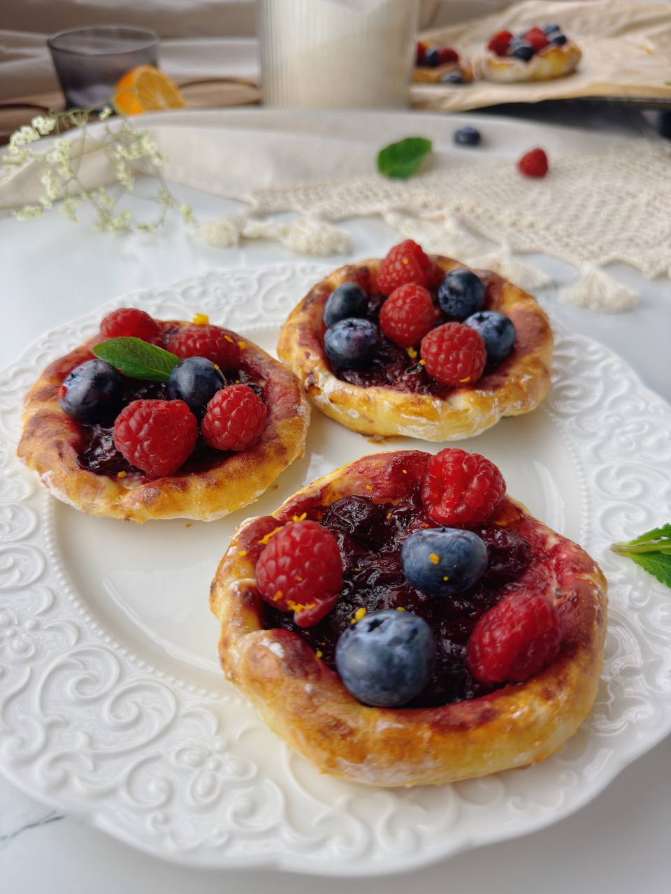 Rustic cherry galettes served with fresh berries and mint