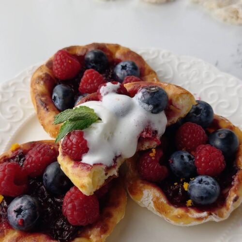 Cherry cottage cheese galettes served with ice cream and fresh berries