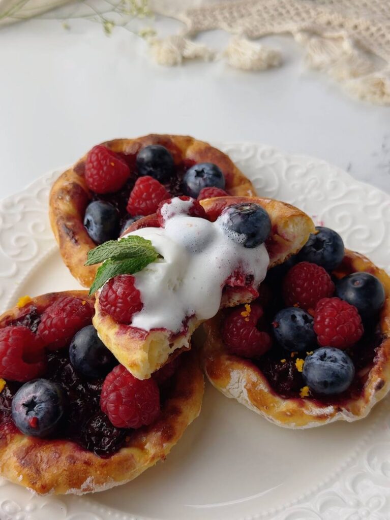 Cherry cottage cheese galettes served with ice cream and fresh berries