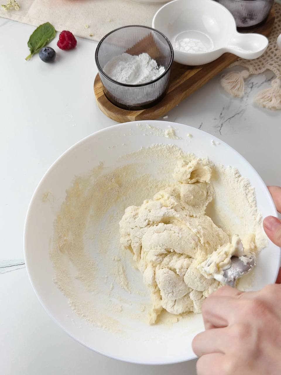 Mixing and kneading soft cottage cheese dough until smooth