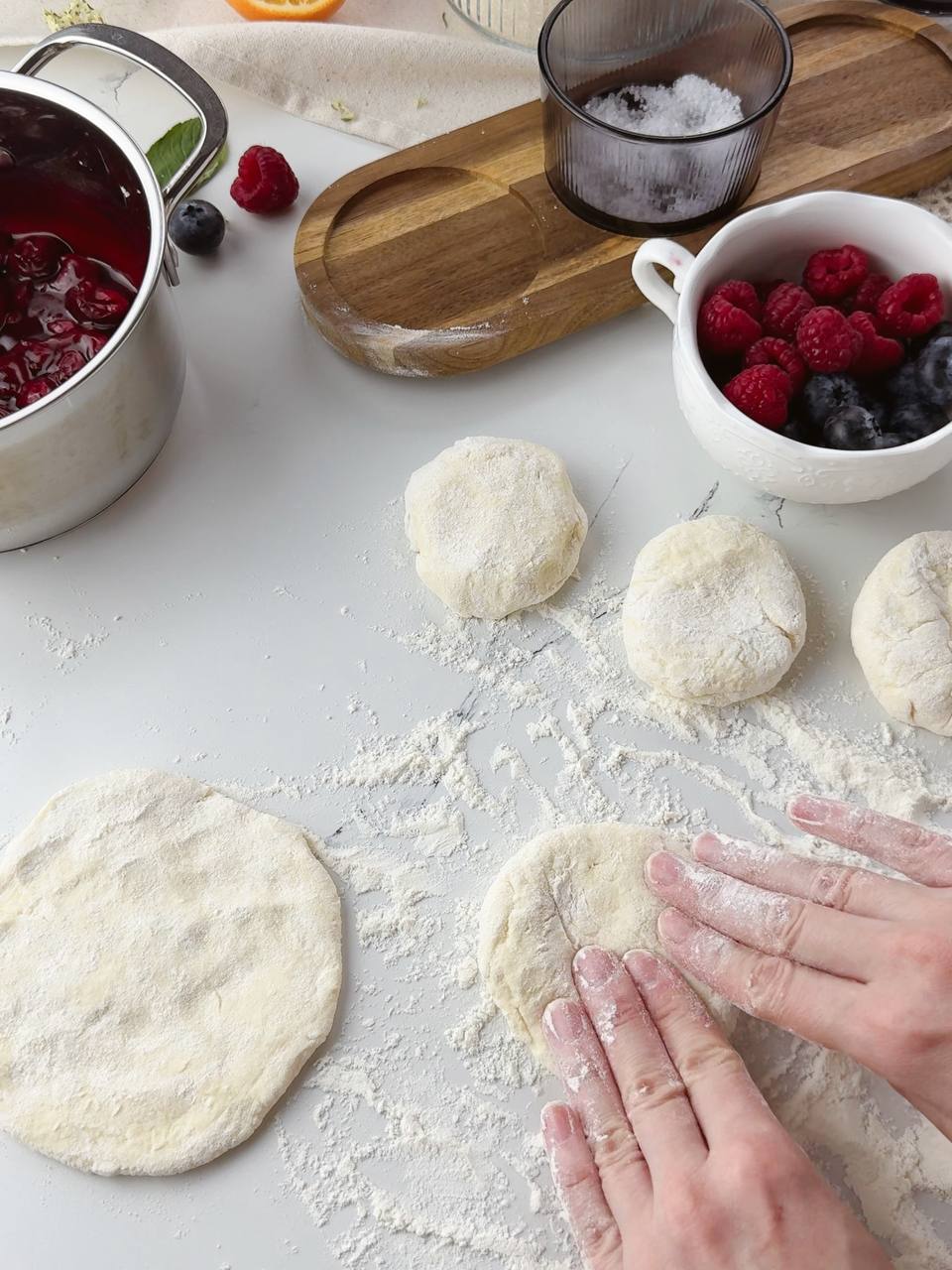 Shaping small dough rounds by hand for rustic galettes