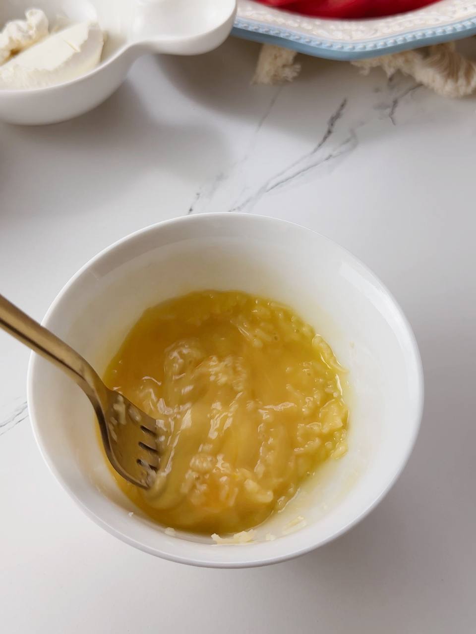 whisking egg with grated cheese for zucchini sandwich base