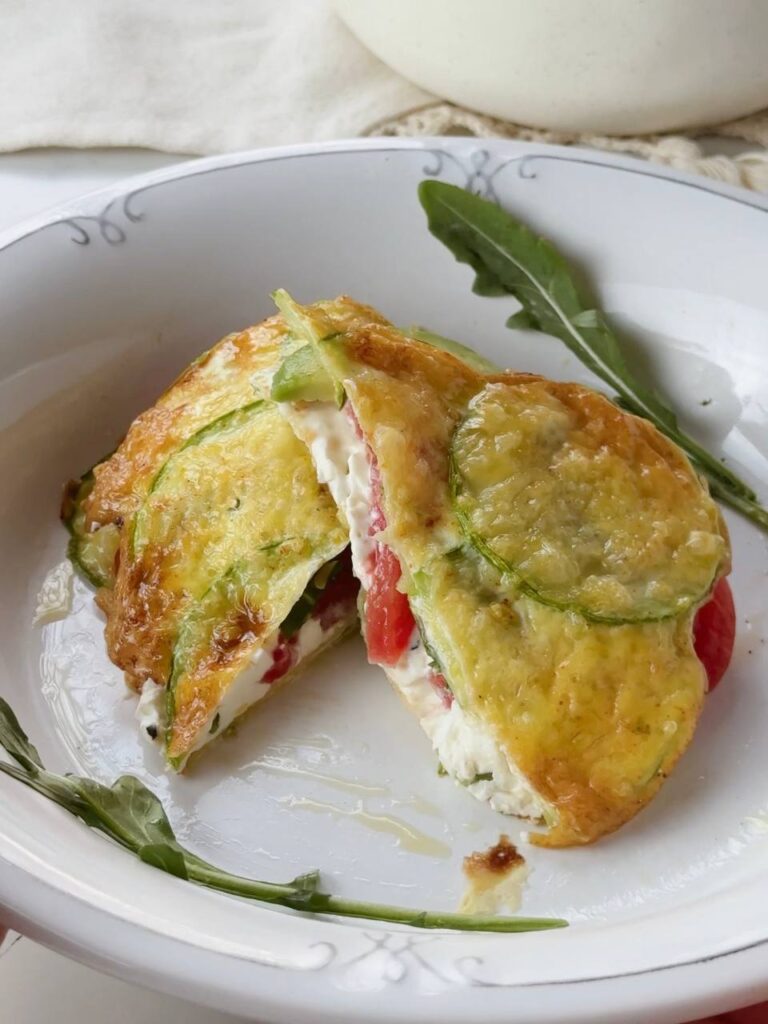 close up of sliced zucchini breakfast sandwich with creamy filling