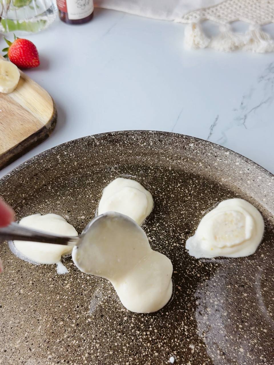 cooking banana pancakes in pan with oil