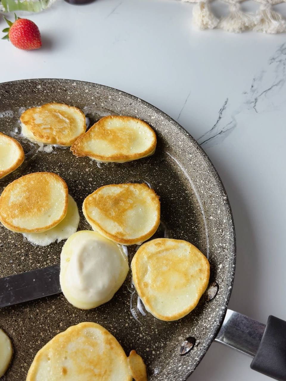 flipping banana pancakes with golden crust