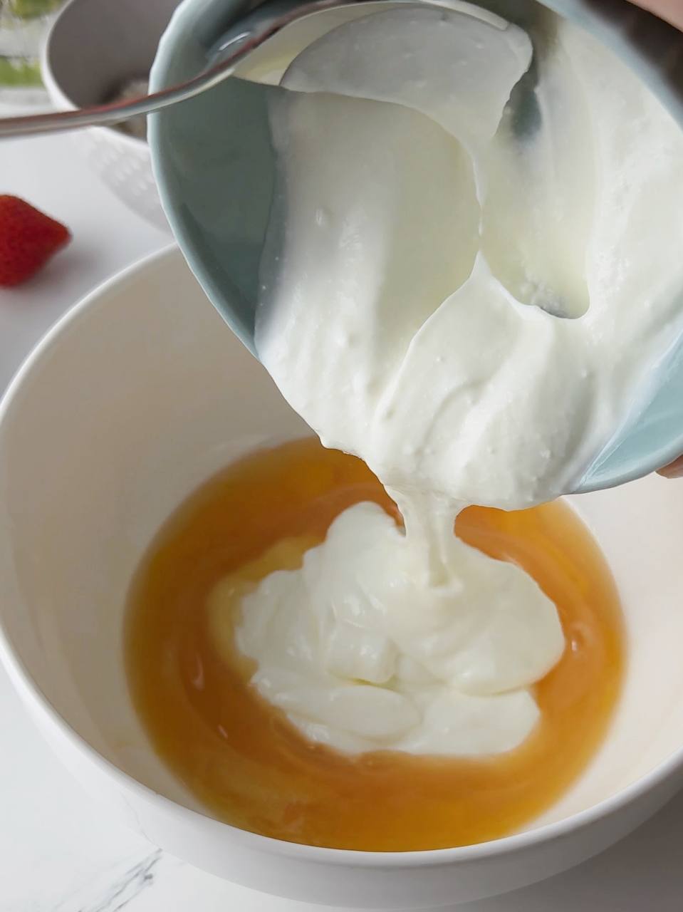 mixing egg and greek yogurt for banana pancakes