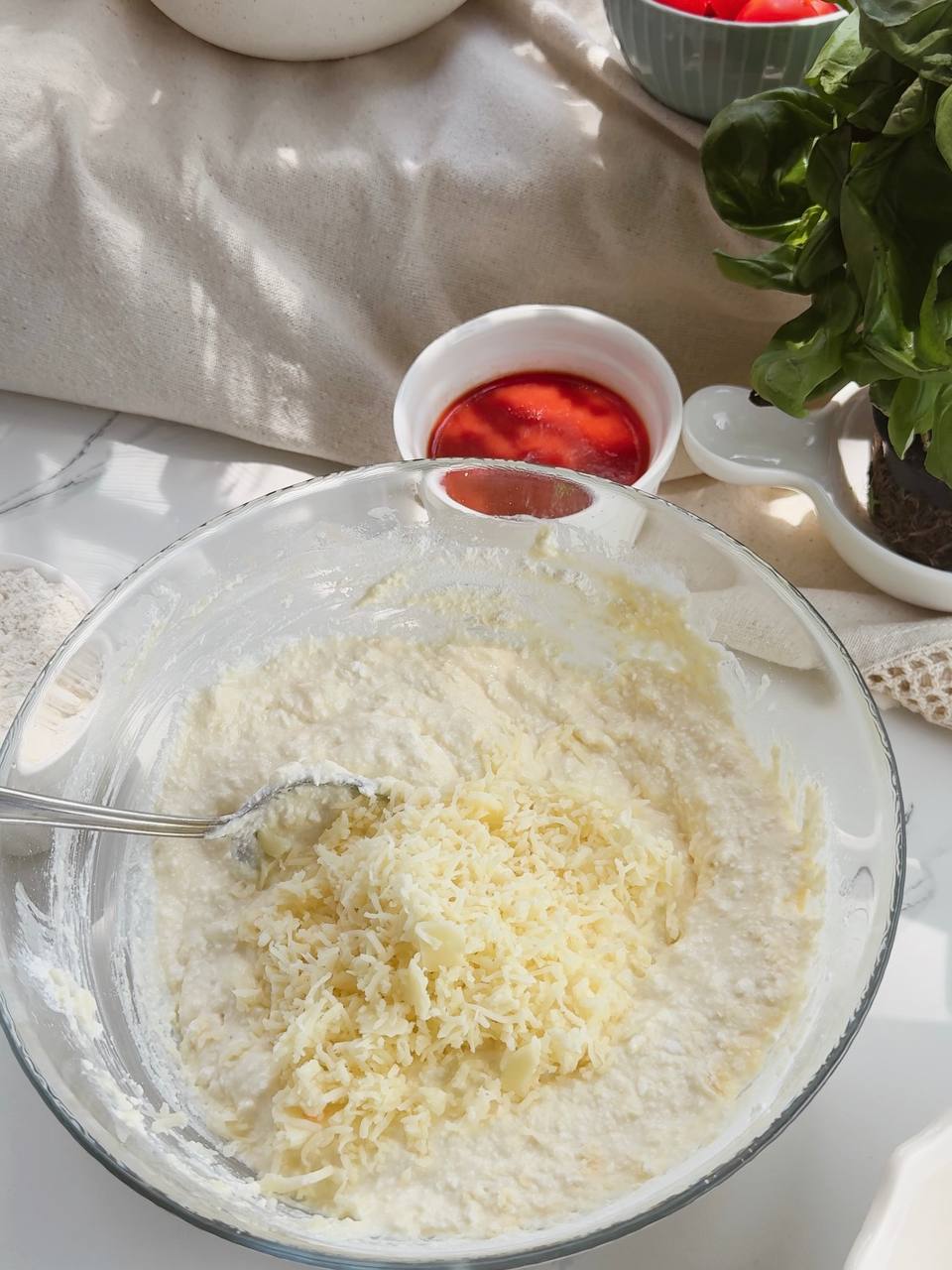 adding grated cheese to the cottage cheese mixture