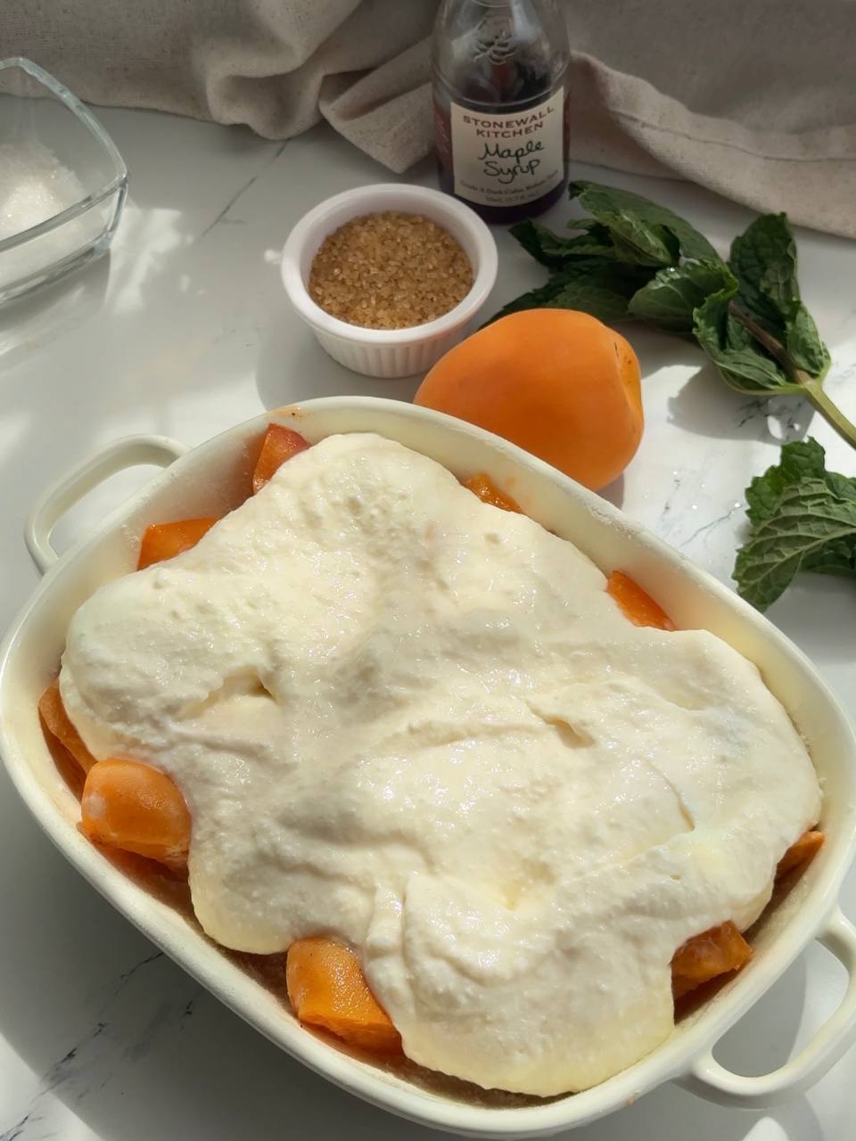 spreading cottage cheese filling over the apricots