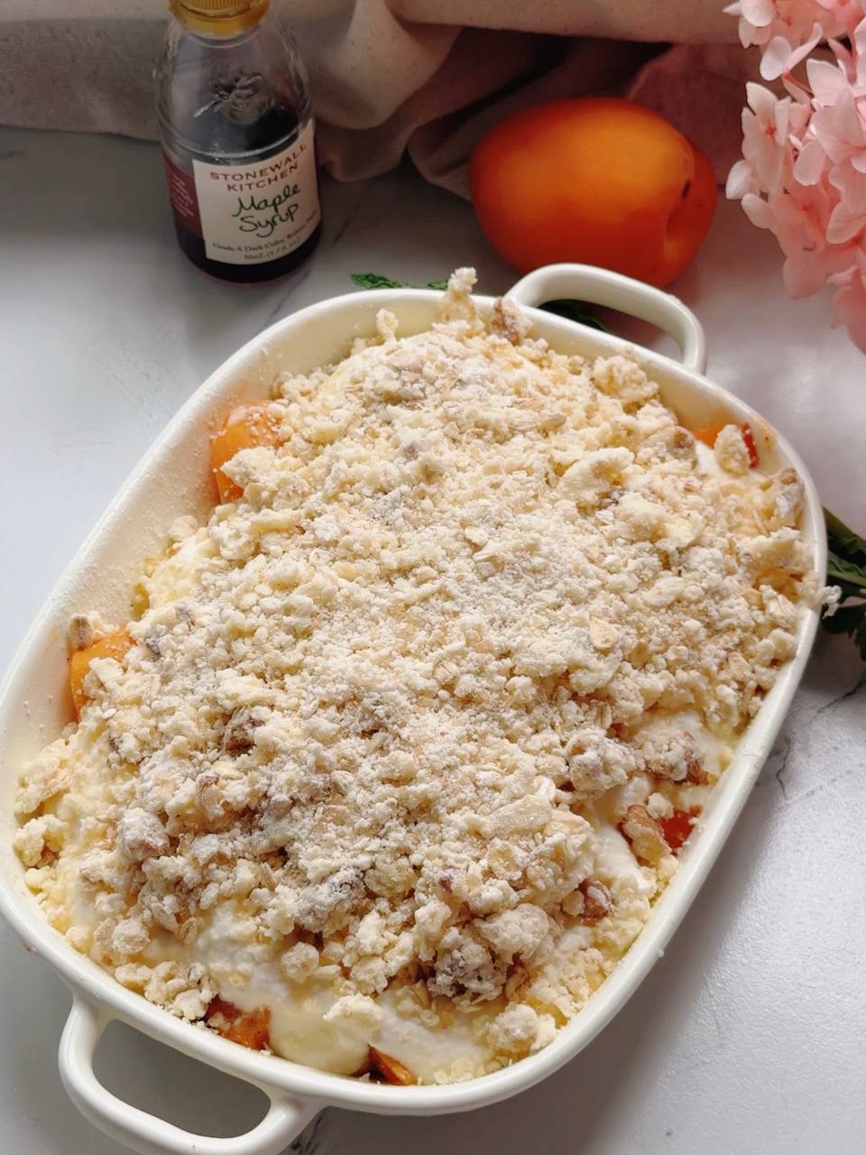 sprinkling crumble topping over the cottage cheese filling