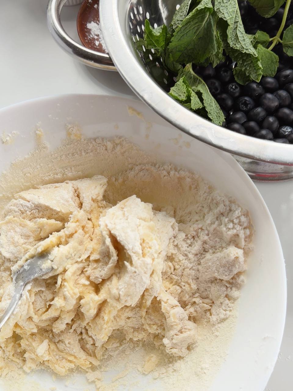 adding flour to the pie dough mixture