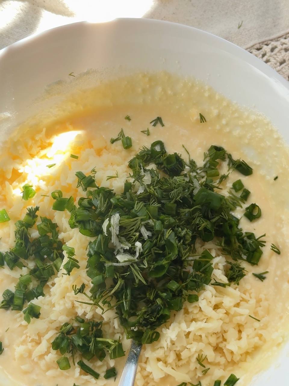 adding fresh herbs and garlic to the cottage cheese batter