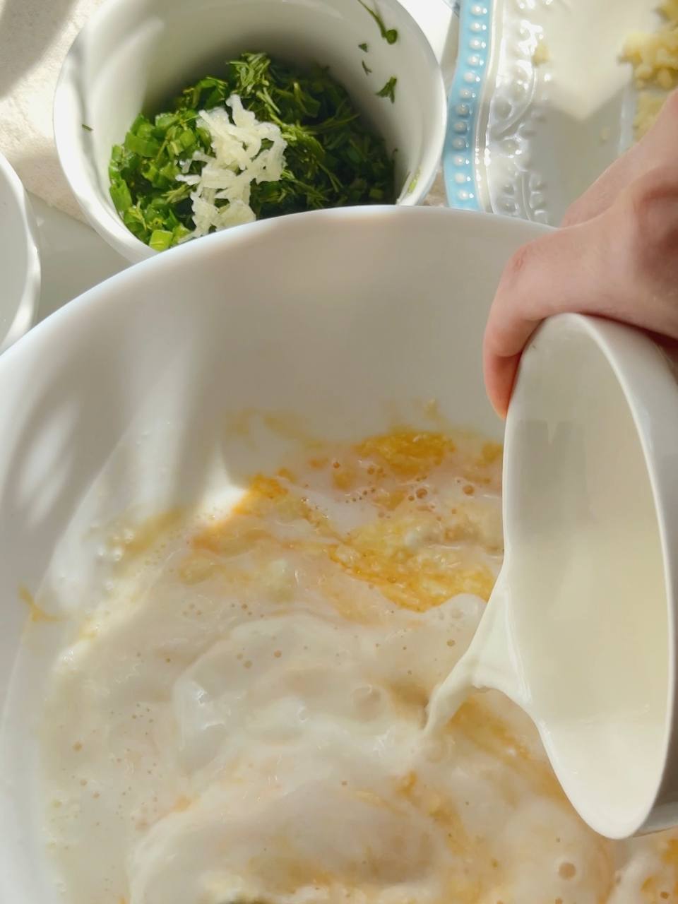 adding milk to the cottage cheese mixture