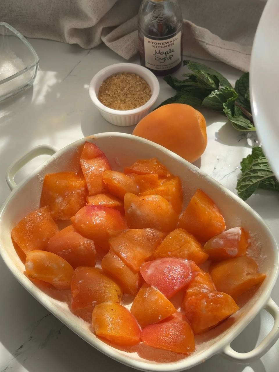 layer of fresh apricots arranged in a baking dish