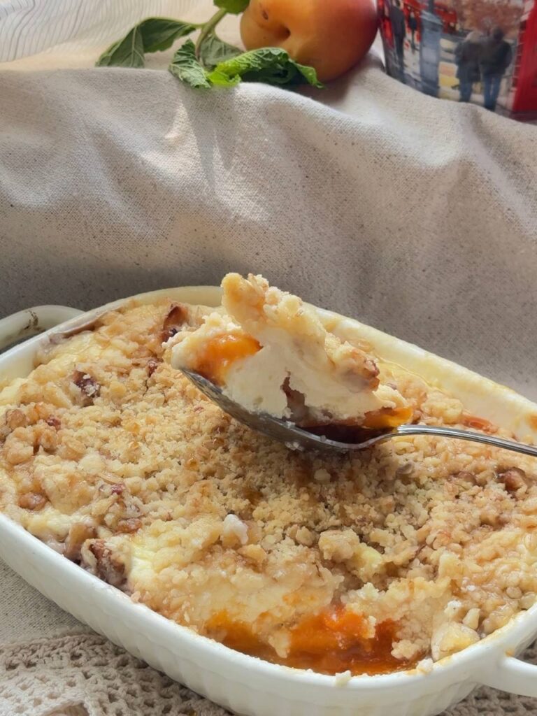Baked apricot cottage cheese crumble served warm with a spoon