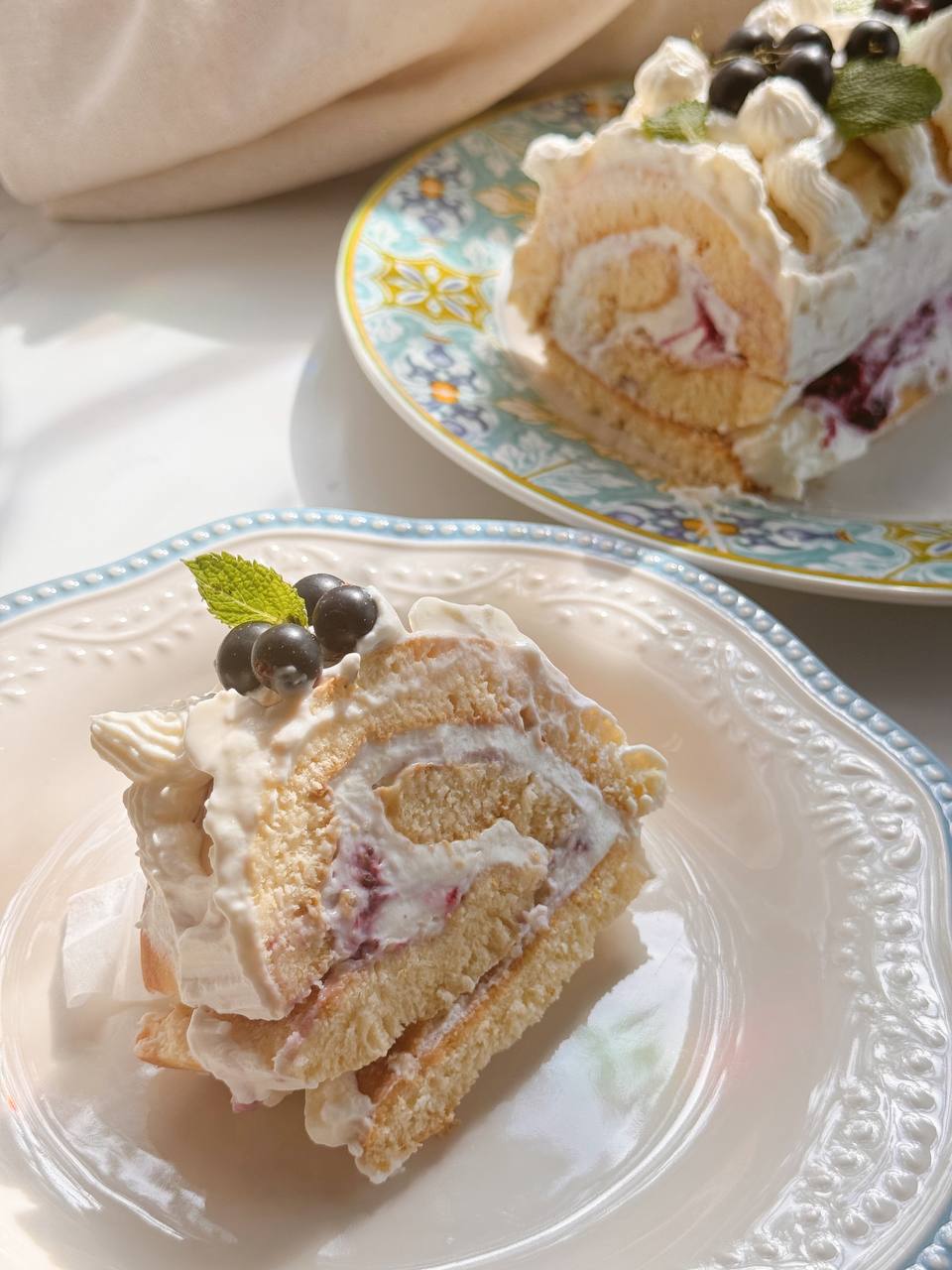 slice of berry roll cake with cottage cheese cream filling