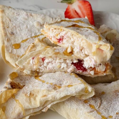 close up of a cottage cheese breakfast wrap with strawberry, banana, and apricot filling