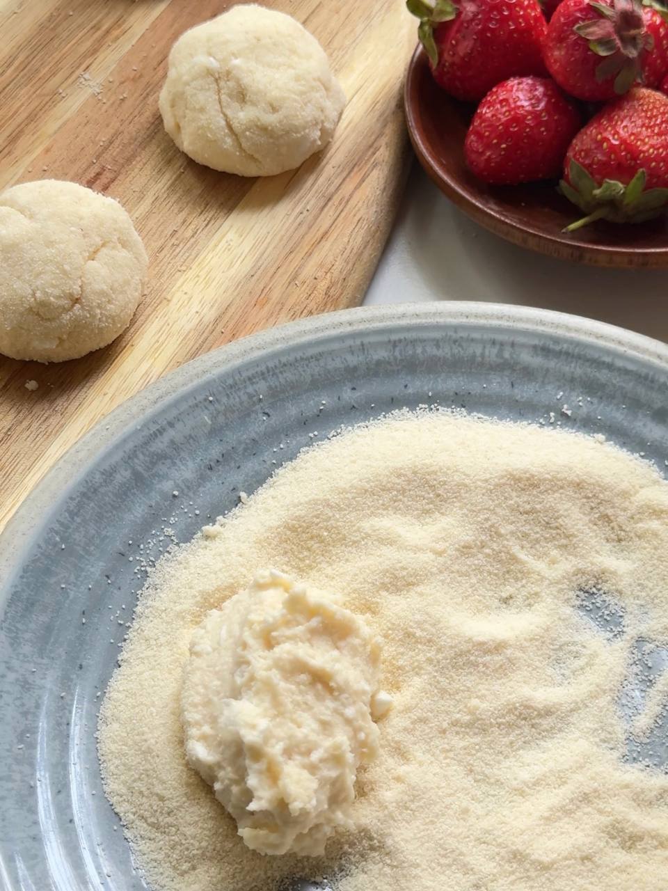 rolling cottage cheese donuts in semolina before frying