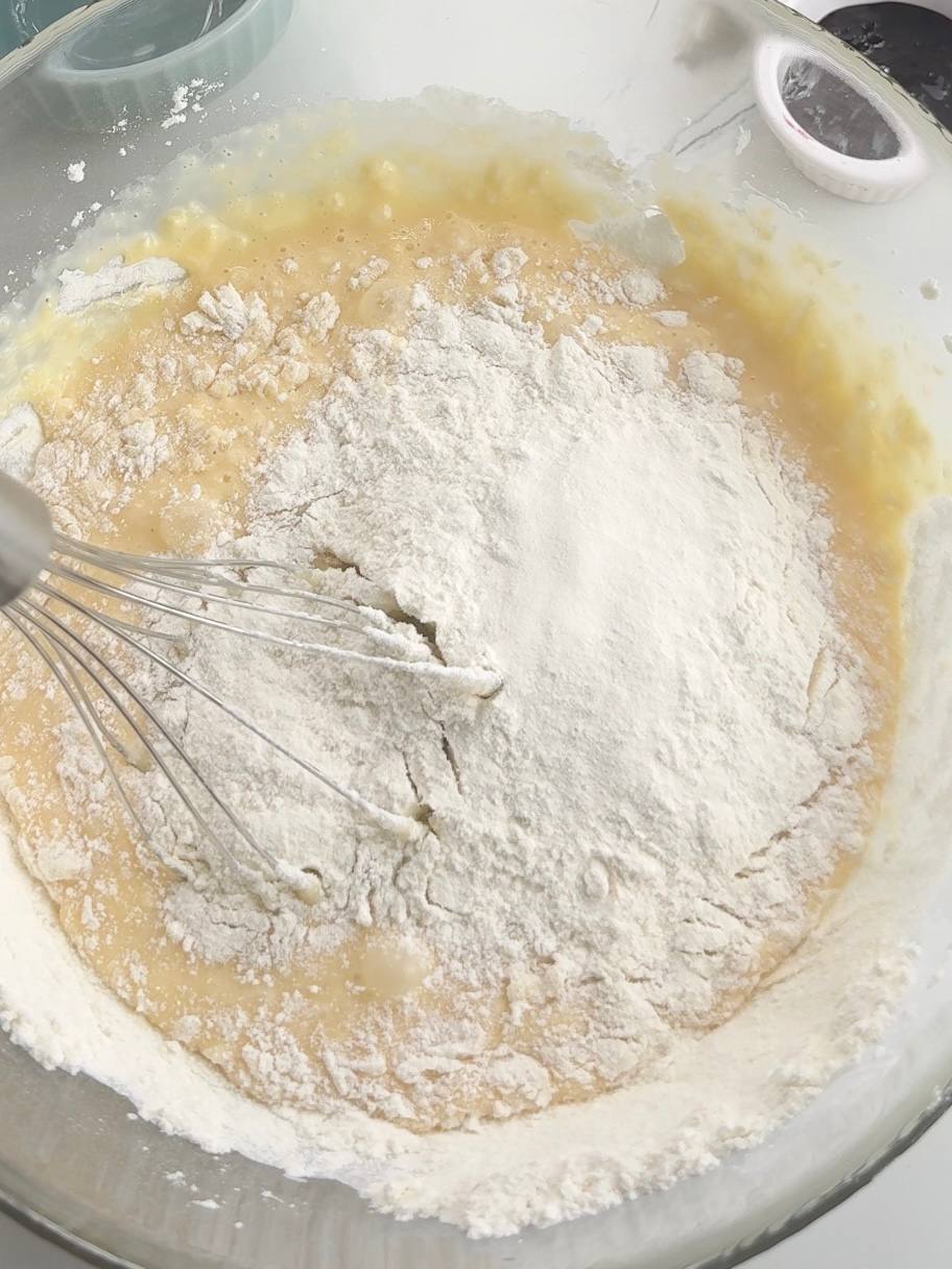 mixing condensed milk, eggs, flour, and baking powder for the sponge