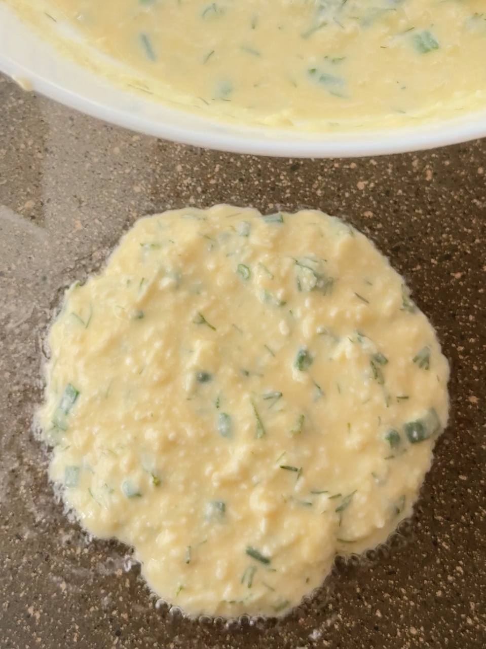 cooking cottage cheese fritters in a frying pan