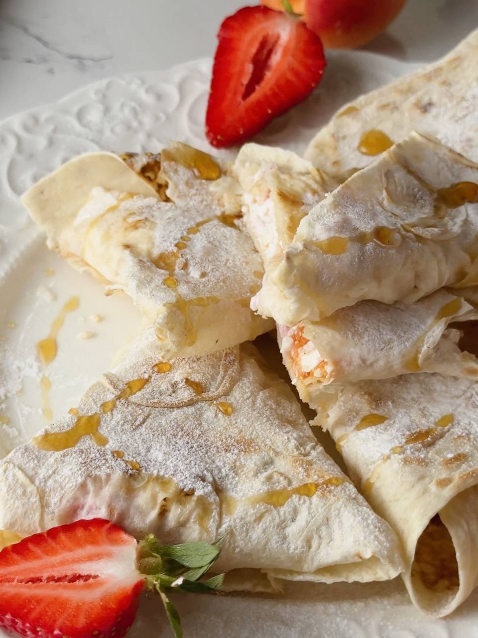 crispy cottage cheese breakfast wraps served with powdered sugar and maple syrup