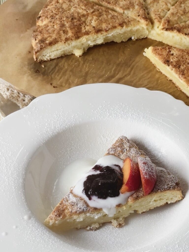 cottage cheese scones served with Greek yogurt, blackcurrant jam, and apricots