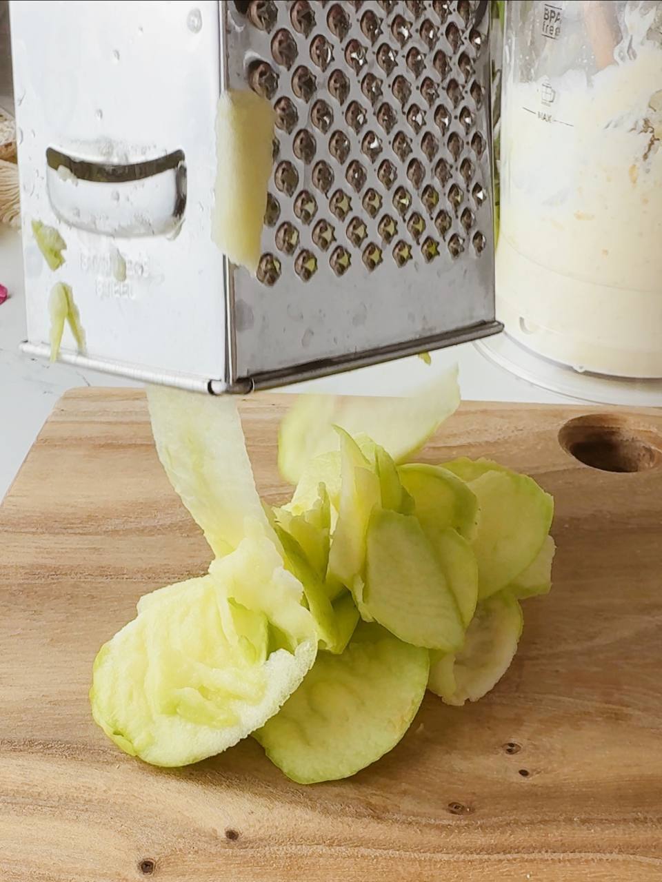 grating a fresh apple for cottage cheese oatmeal bake