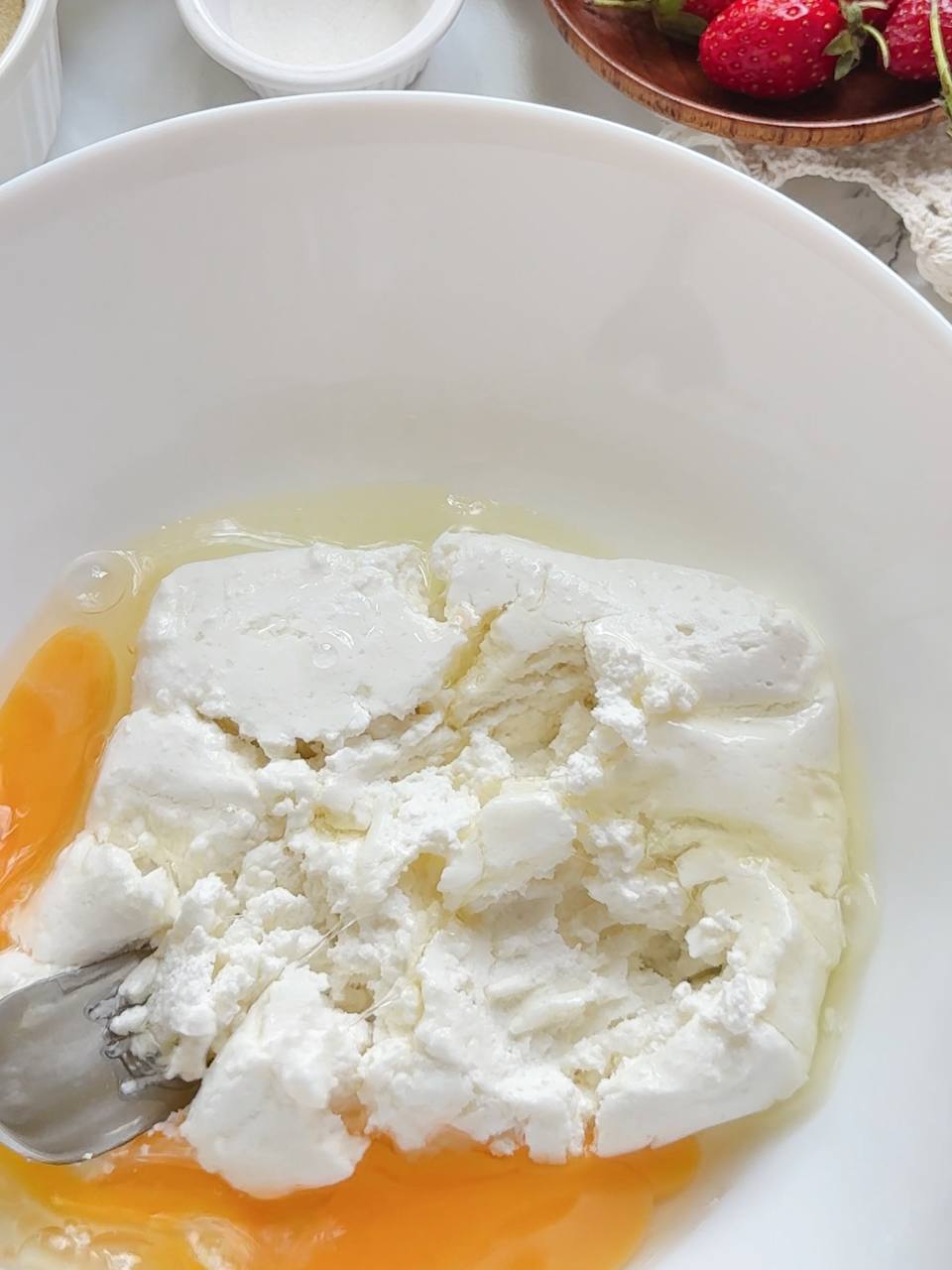 mixing cottage cheese and egg for the donut dough