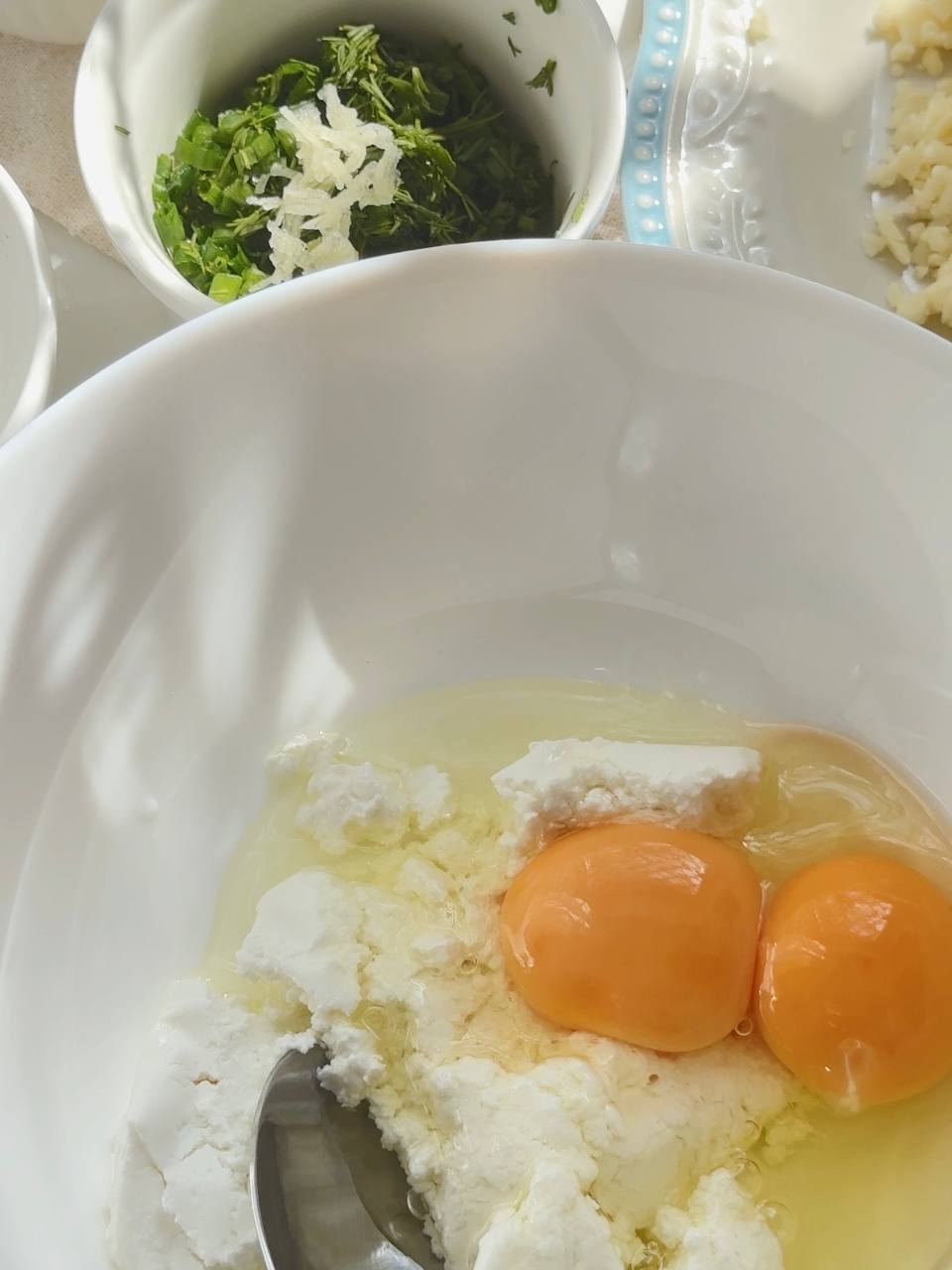 mixing cottage cheese with eggs for the fritter batter