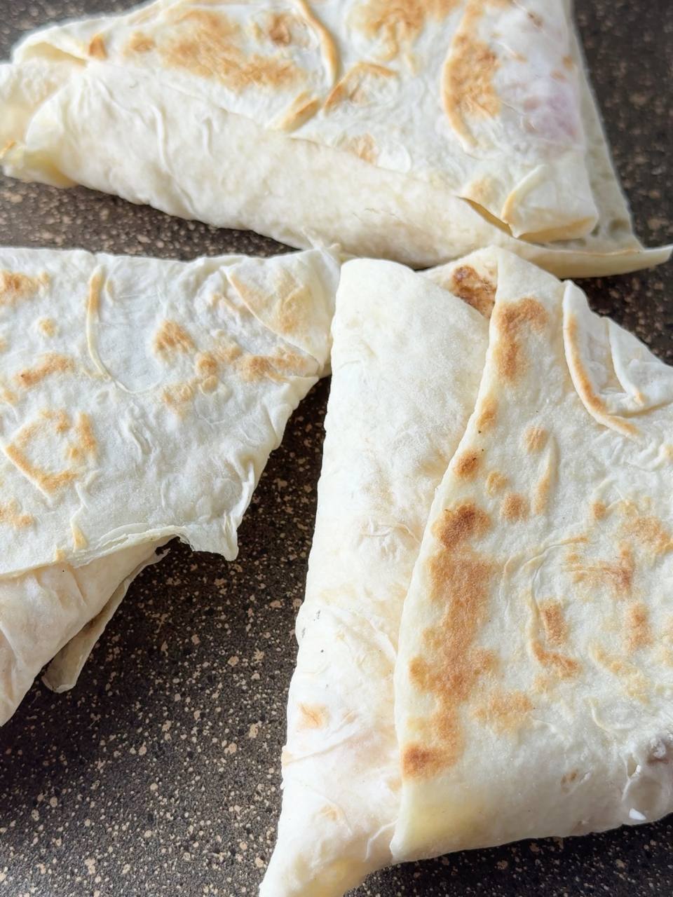toasting cottage cheese breakfast wraps in a dry pan until golden