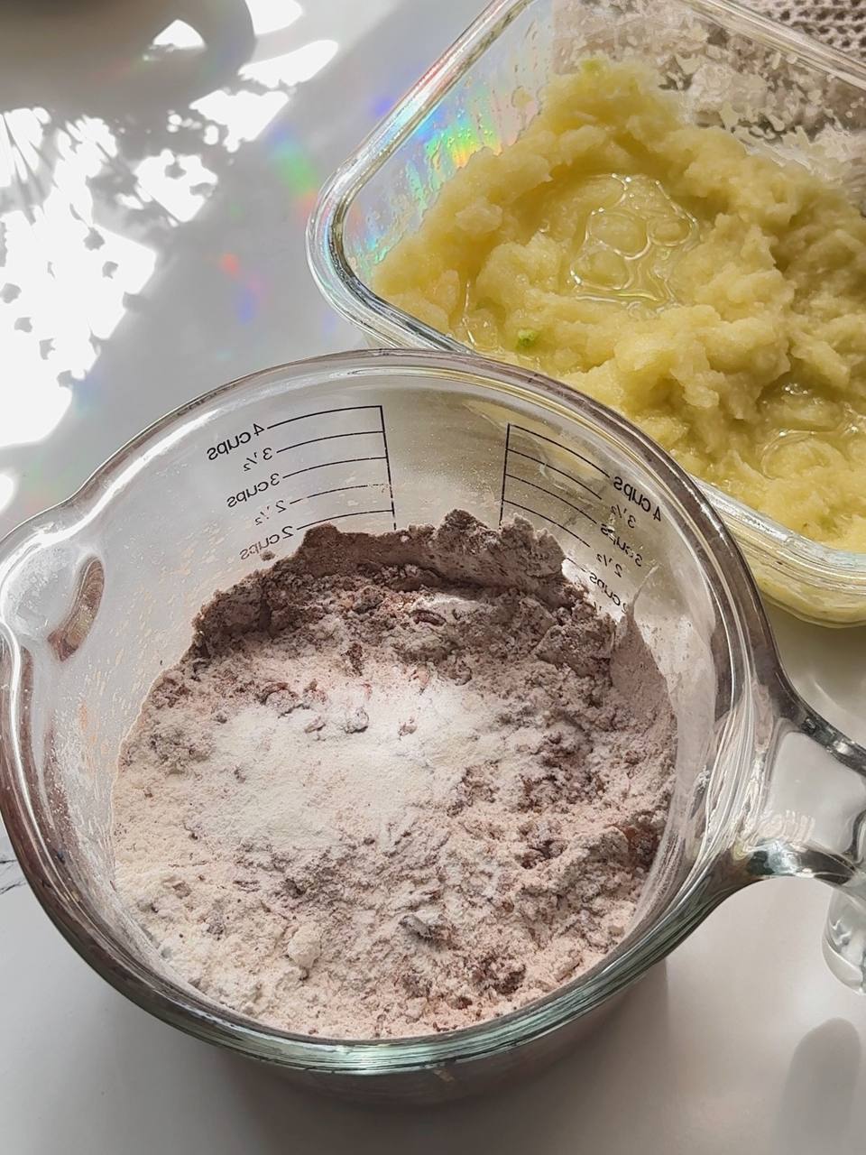 adding cocoa powder and flour to the brownie batter