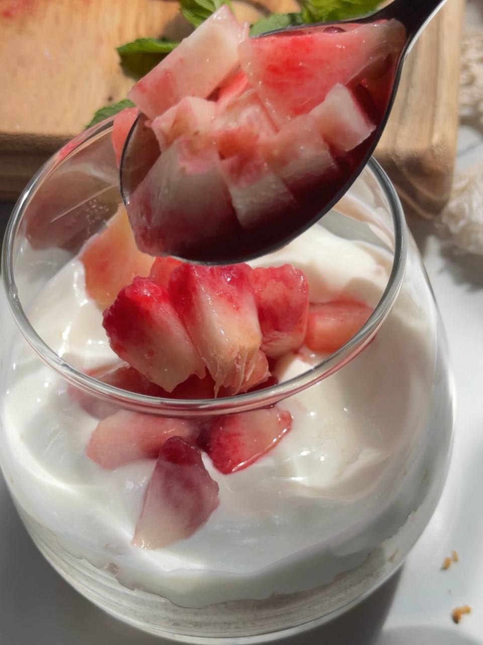 adding fresh diced peaches to the cheesecake cups