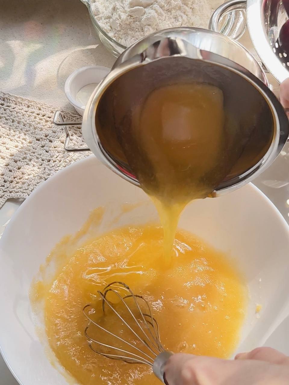Adding melted butter to the cake batter