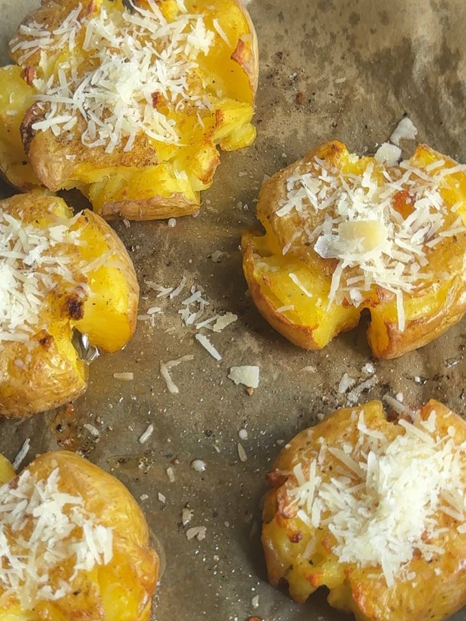 sprinkling grated Parmesan over the smashed potatoes